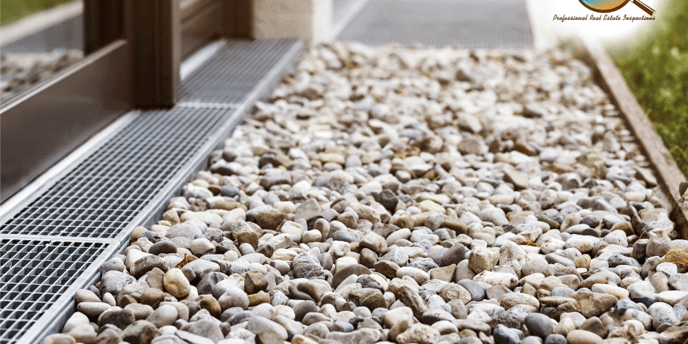 Gravel and drainage system outside a home inspected by Rod Inspects in San Antonio TX for foundation and water management